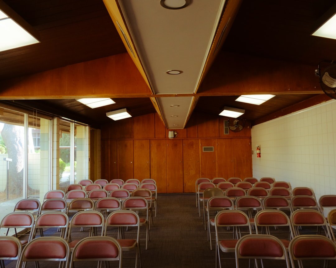 Bright community hall with chairs set up for a club meeting