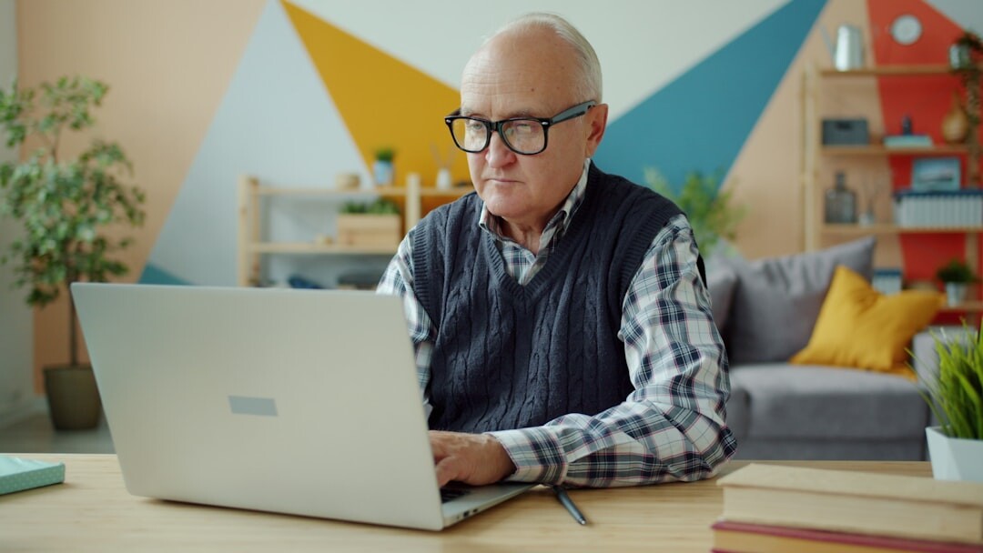 Senior woman learning to use a laptop in a computer class