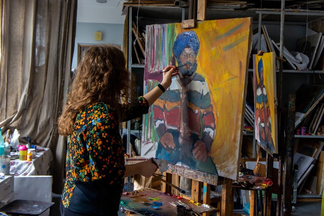 Senior woman painting on canvas during an art workshop
