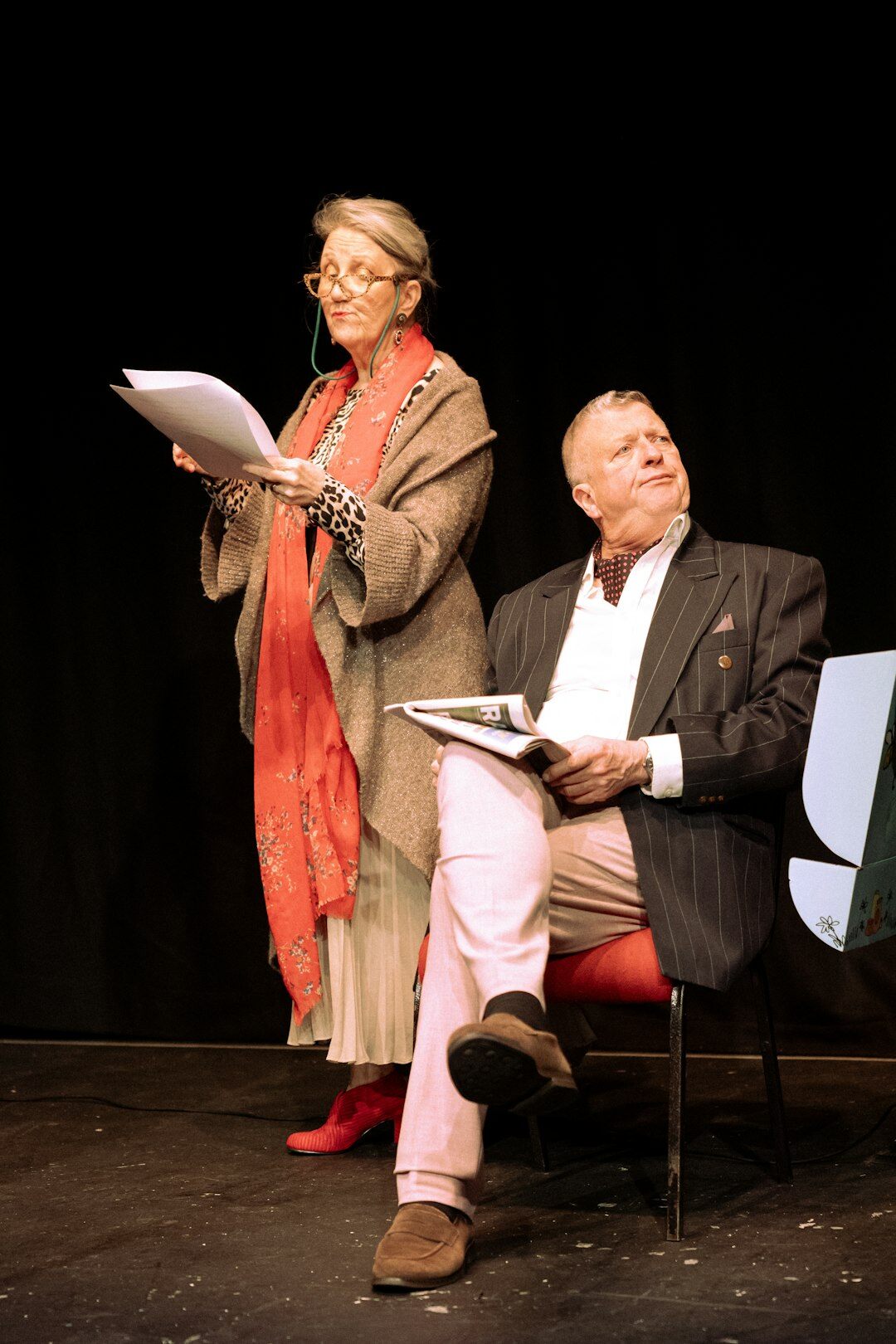 Senior couple dressed up attending a theatre performance